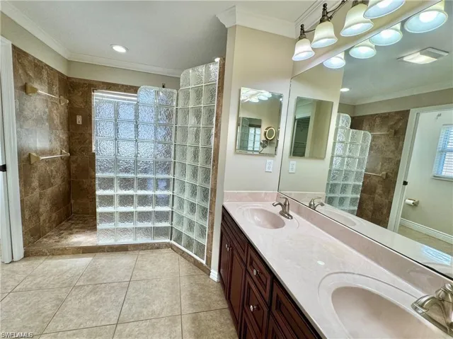 Spacious bathroom featuring a double vanity with integrated sinks and a large wall-mounted mirror