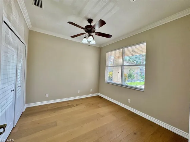 Neutral wall tones complement the wood-finish flooring