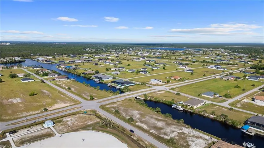 View of property location with a nearby body of water and nearby suburban area