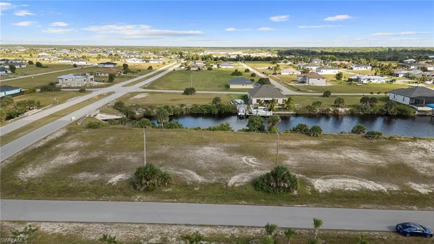 Aerial view of residential area featuring a large body of water