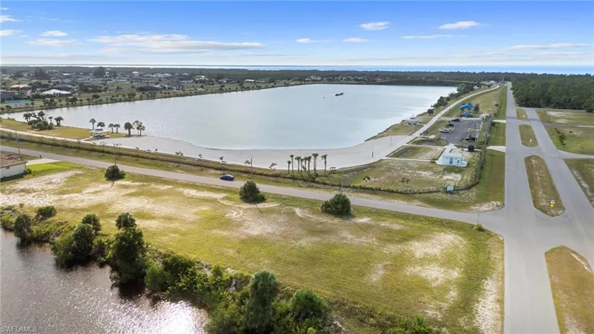 Aerial view of property and surrounding area featuring a large body of water