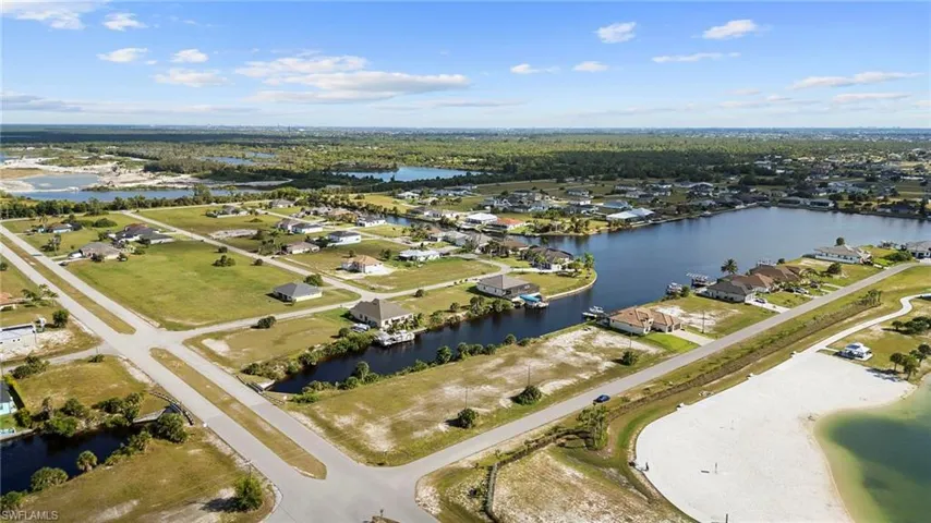 Aerial view of property's location with a nearby body of water and nearby suburban area