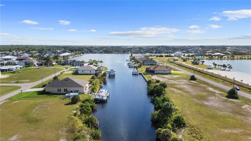 Aerial perspective of suburban area featuring a large body of water