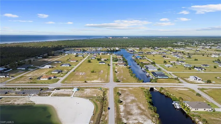 Aerial overview of property's location with a large body of water and nearby suburban area