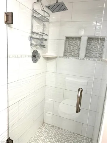 Full bathroom featuring a shower stall