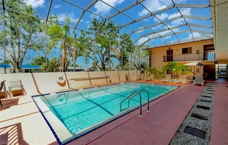 Community pool with a patio area, a sunroom, and a lanai