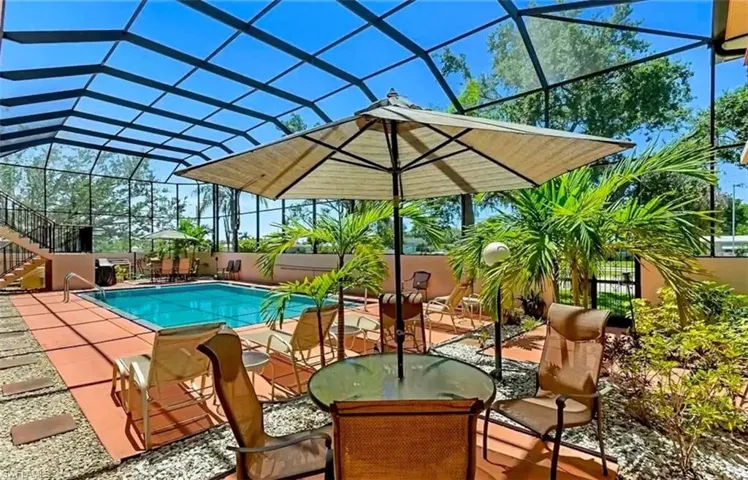 View of pool featuring a lanai, a patio area, a sunroom, and stairs