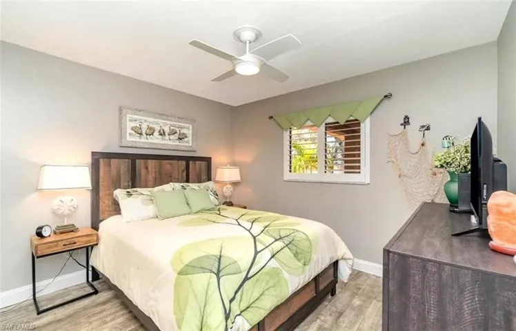 Bedroom with wood finished floors and a ceiling fan