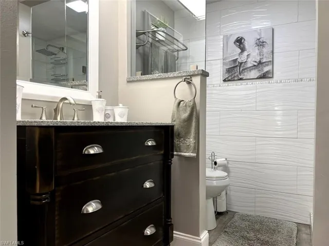 Bathroom with vanity and tiled shower