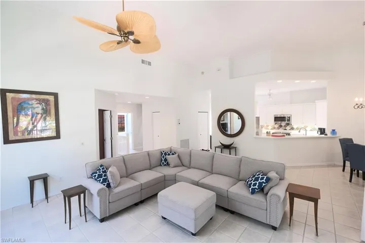 Tiled living room featuring ceiling fan