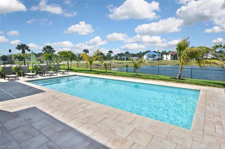 Numerous palm trees surround the pool deck for a resort feel!