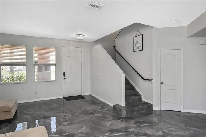Tile flooring continues on the stairs with safety treads.