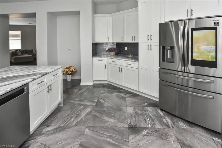 Grab a snack from the new Samsung 4-door French Door Touchscreen Refrigerator...