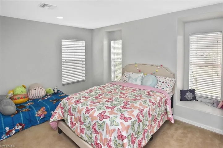 Guest bedroom #1 with cozy window seating, perfect for reading or daydreaming.