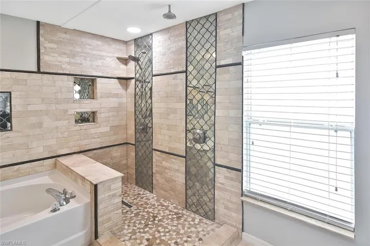 Luxury shower with dual showerheads and custom tilework!