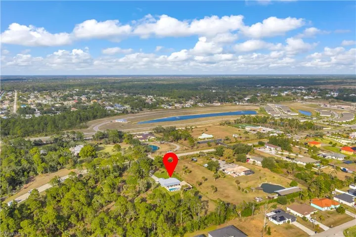 View of property location featuring a large body of water and nearby suburban area