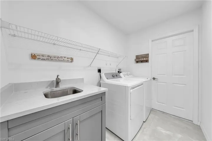 Laundry room featuring washer and clothes dryer and cabinet space