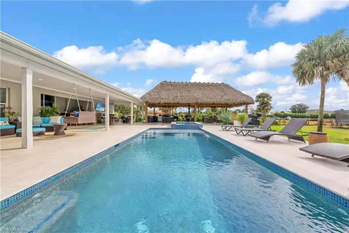 View of swimming pool with an outdoor hangout area, a patio, and a pool with connected hot tub