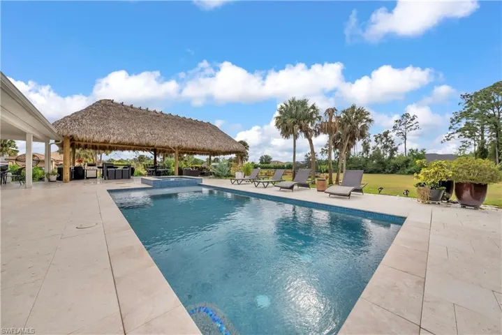 View of pool featuring a patio and a pool with connected hot tub