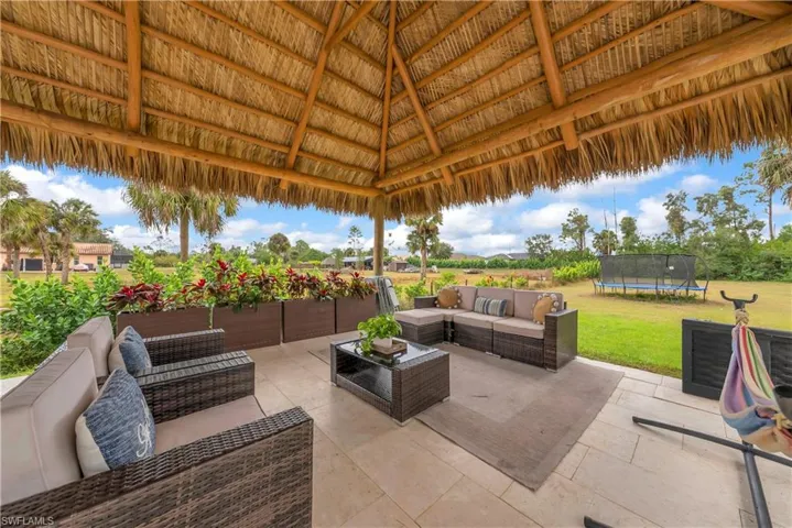 View of patio featuring a trampoline and outdoor lounge area