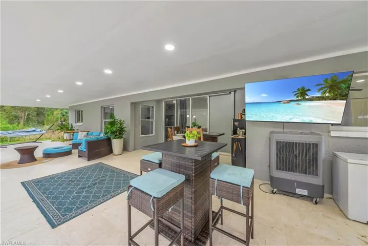 View of patio / terrace with heating unit, outdoor dining space, and outdoor lounge area