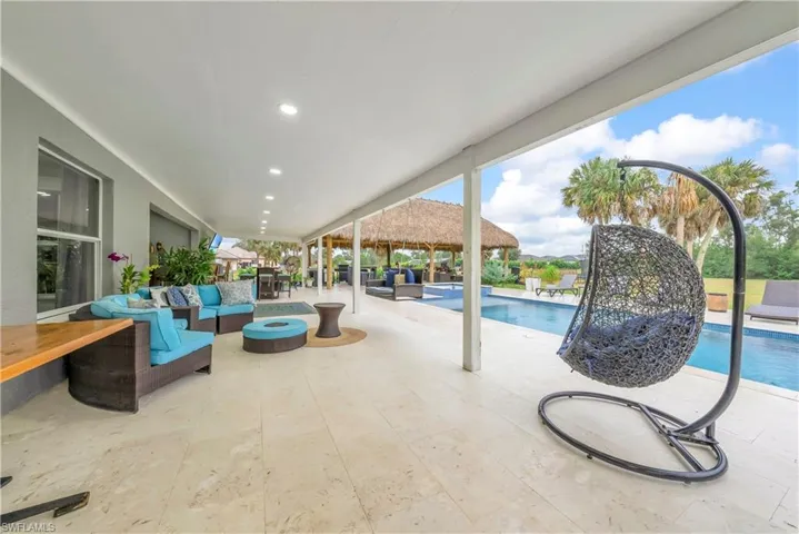 View of swimming pool with an outdoor living space, a patio area, and a pool with connected hot tub