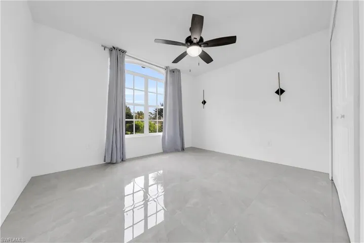 Unfurnished room featuring a ceiling fan