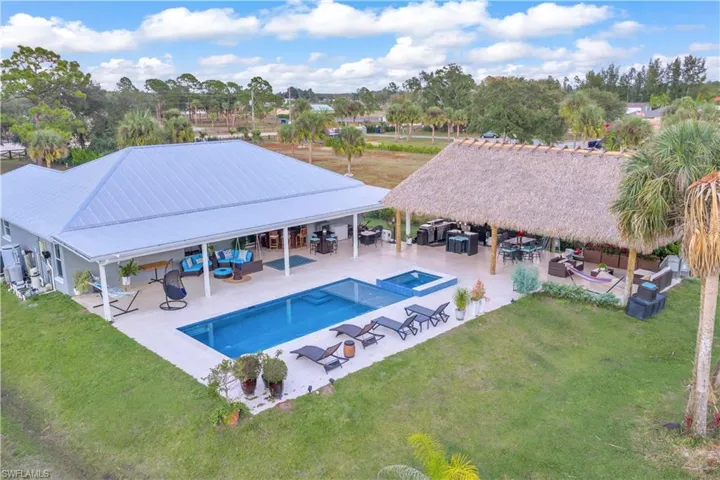 Rear view of house with a patio, an outdoor hangout area, and a yard