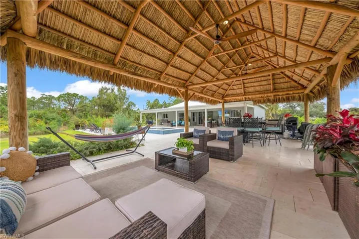 View of patio / terrace featuring outdoor lounge area, a ceiling fan, outdoor dining space, and a pool with connected hot tub