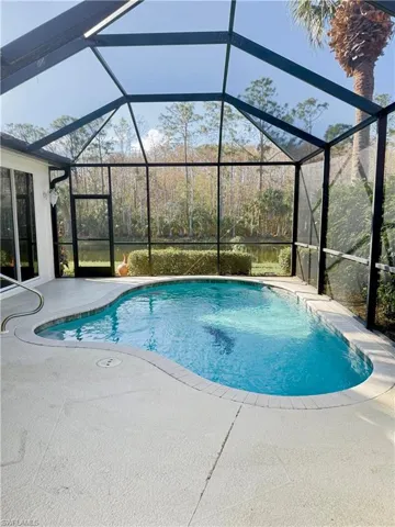 Large Lanai area with a private gorgeous  preserve view seen through the rooms of this house