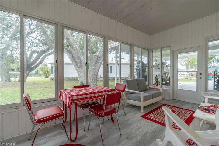 Lanai with partial view of side and carport