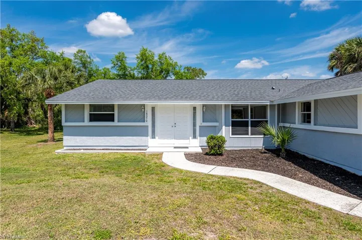 Single story home with a front lawn