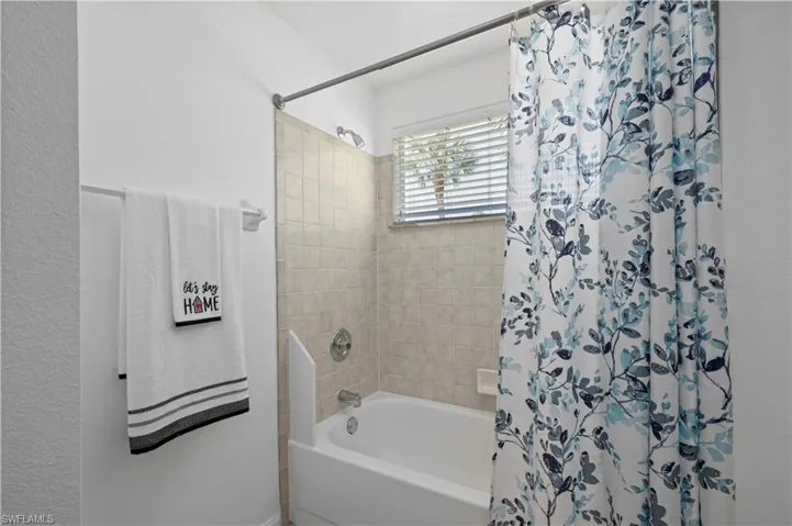Bathroom featuring shower / bath combination with curtain
