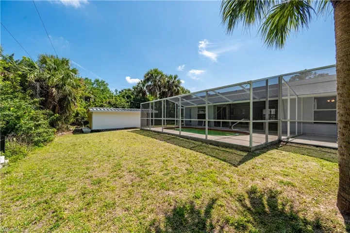 View of yard with a patio and a lanai