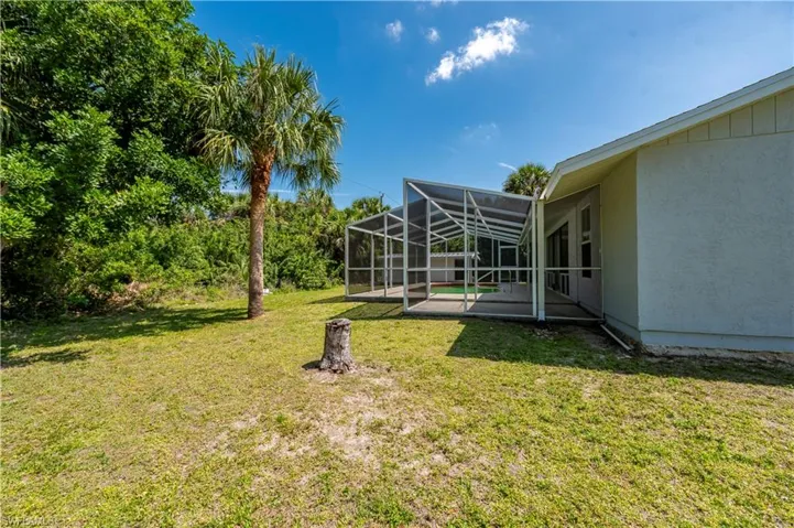View of yard featuring a patio area and glass enclosure