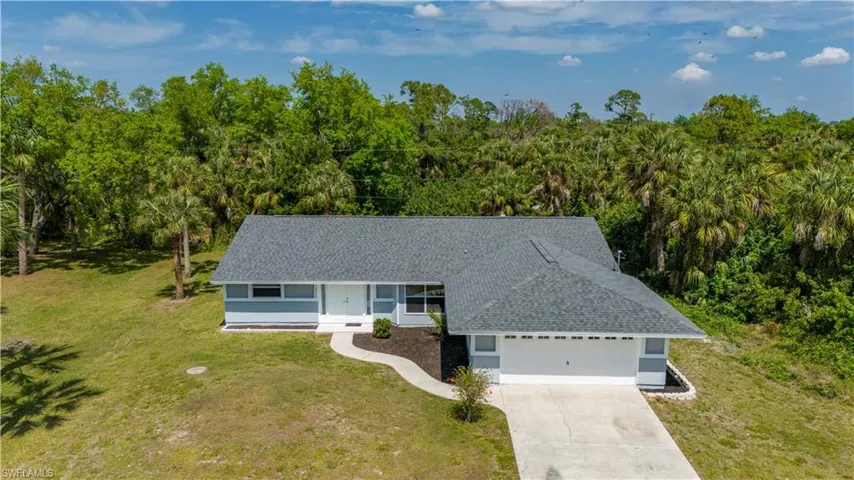 View of front of home with a garage and a front yard