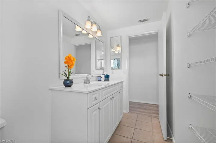 Bathroom featuring vanity and tile floors