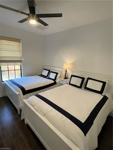 Bedroom featuring dark wood finished floors and a ceiling fan