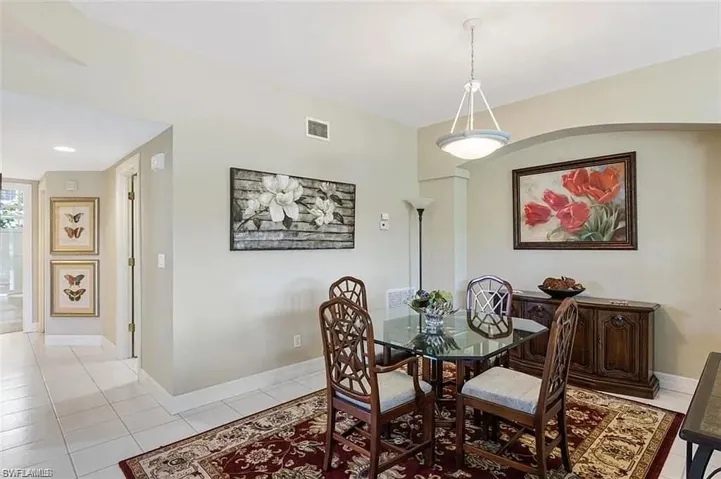 Dining area with light tile patterned floors