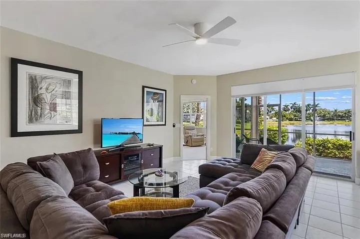 Living room featuring ceiling fan and light tile patterned floors
