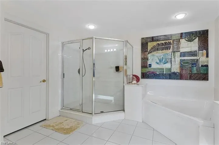 Bathroom featuring separate shower and tub and tile patterned floors