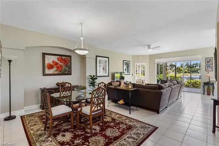 Dining space with light tile patterned flooring and ceiling fan