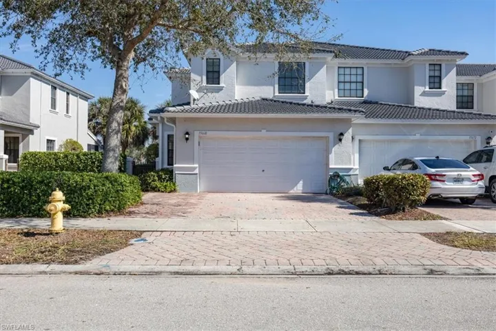 End unit with a double garage and dedicated driveway.