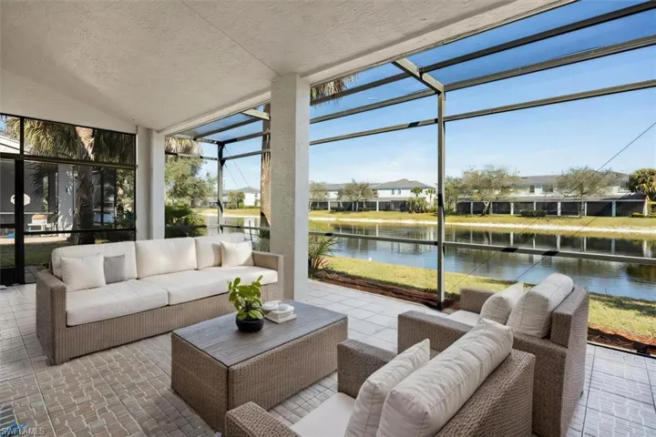 AI Staged - Lanai featuring a water view, a residential view, a wealth of natural light, and lofted ceiling