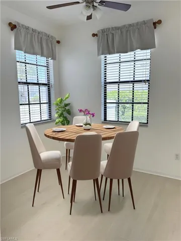 AI Staged - Dining room featuring baseboards, light wood finished floors, and ceiling fan