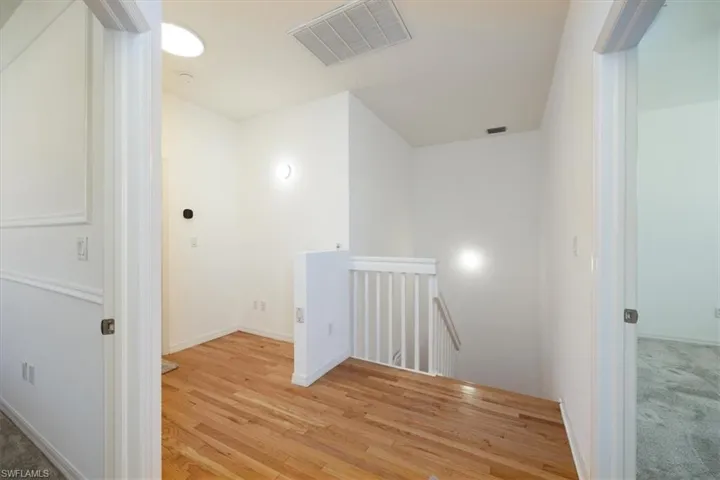 Second floor landing with hardwood flooring.