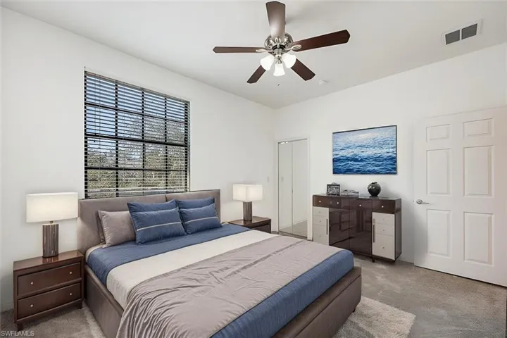 AI Staged - 2nd Bedroom with a ceiling fan, visible vents, and light colored carpet