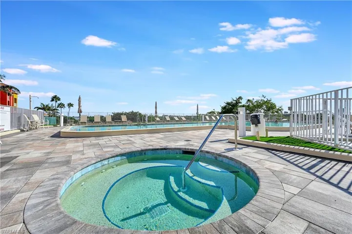 Community pool with a community hot tub and a patio