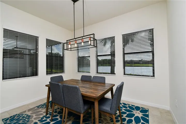 Tiled dining space featuring an inviting chandelier