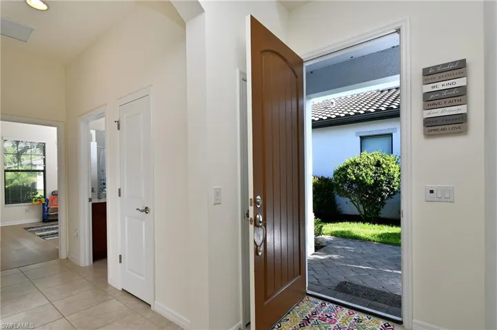 Foyer entrance featuring light tile floors